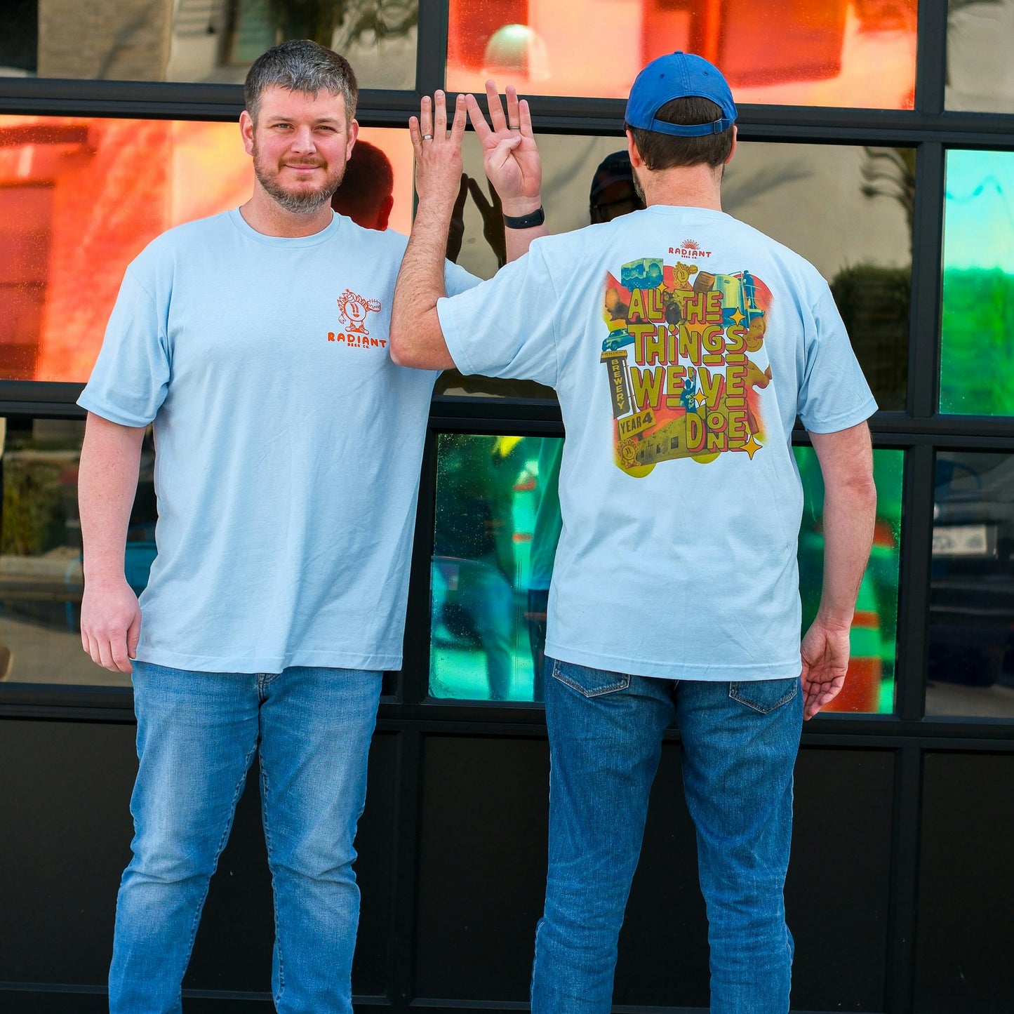 Staff Members showcase the All The Thing's We've Done Anniversary t-shirt