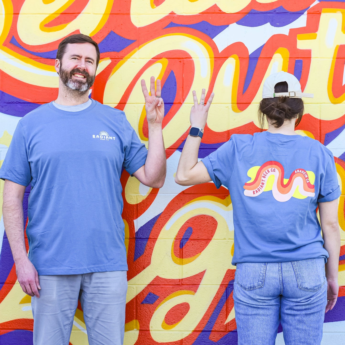 Third Anniversary Shirt featuring our radiant mural on the back of a soft blue shirt.