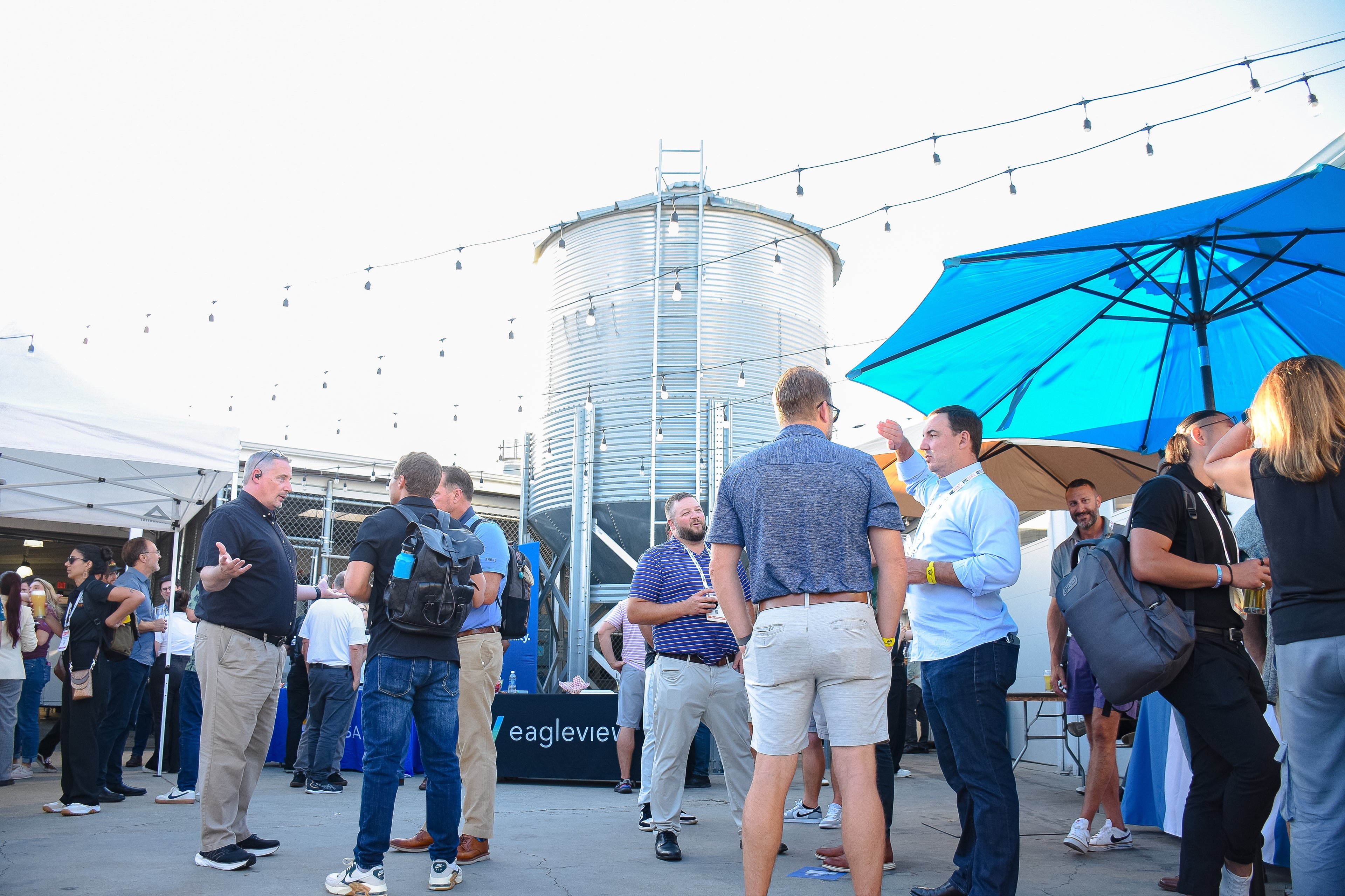 A group of individuals stand on the back patio showcasing the potential for private events