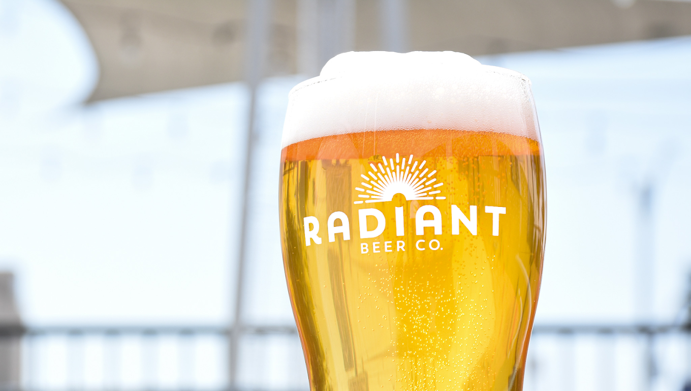 Clear Beer Pour with a Foamy head on the front patio