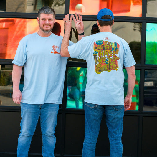Staff Members showcase the All The Thing's We've Done Anniversary t-shirt