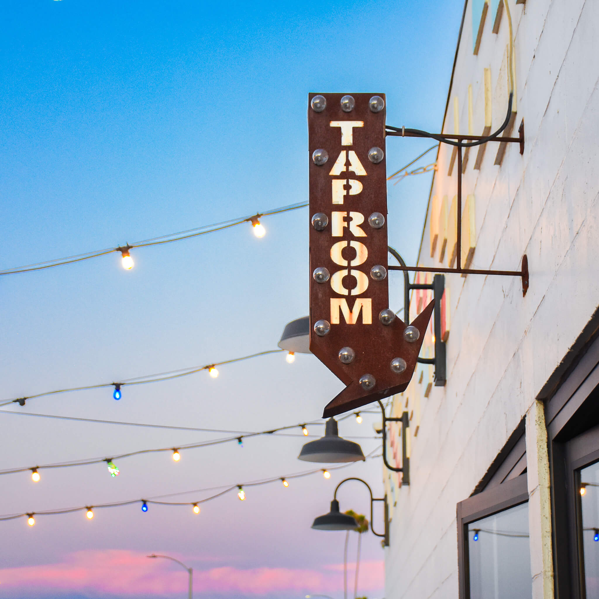 Taproom Sign in front of the sky