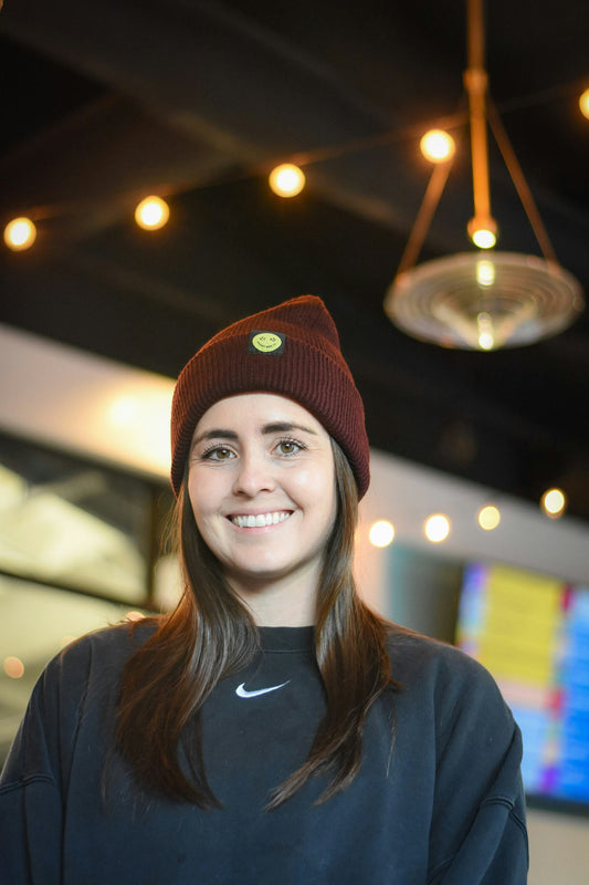 Maroon Beanie with a yellow smily face 
