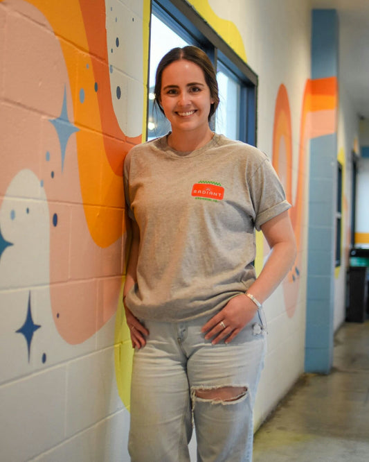 a staff members wears a grey radiant kitchen t-shirt that says Radiant on front 