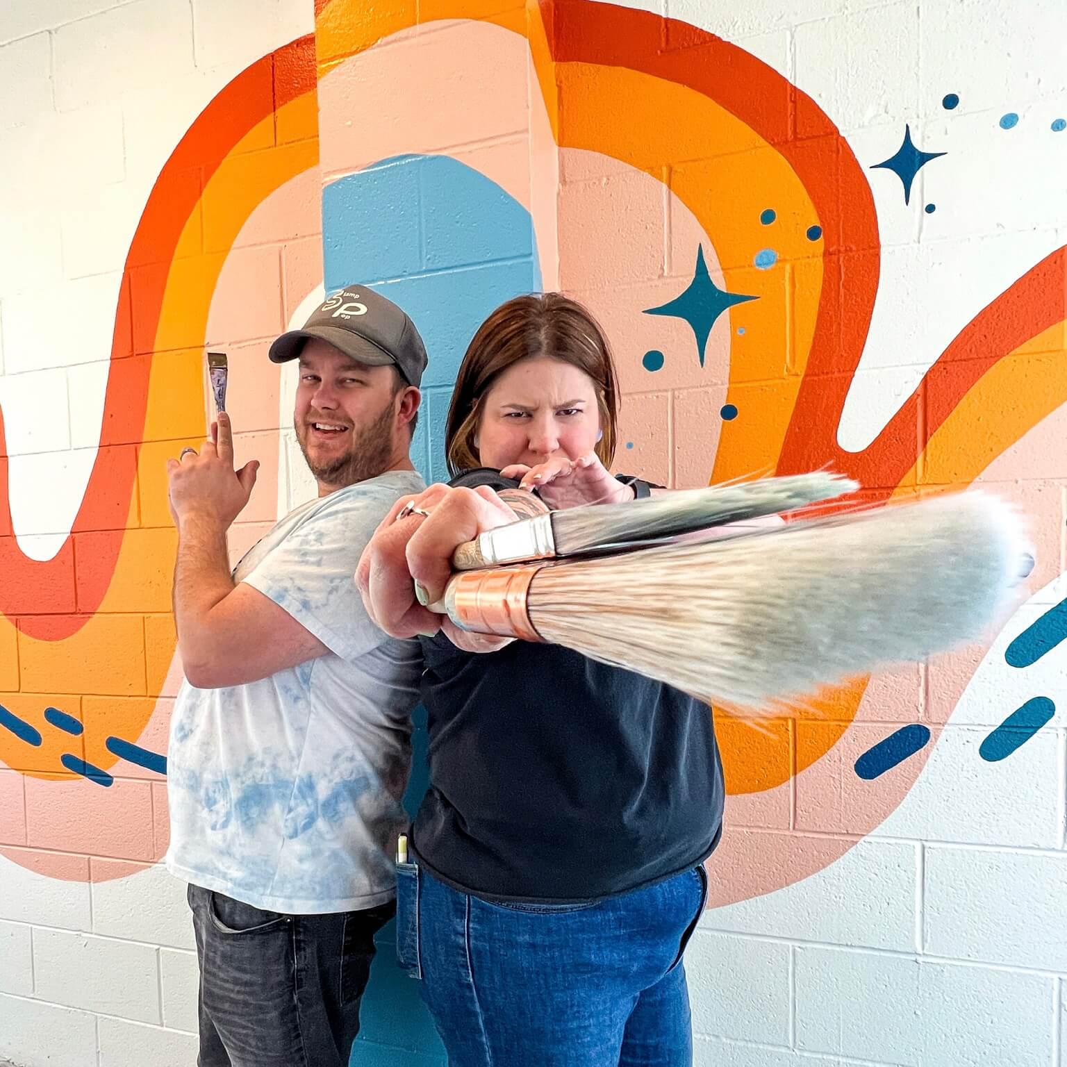 Kim and Chris in front of the mural they painted 